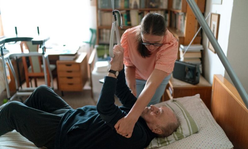 A caregiver assists an elderly man in a home environment, showcasing compassionate home care. - Photo by Jsme MILA on Pexels