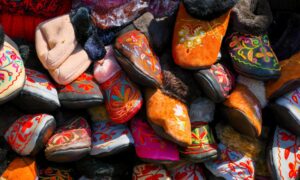 A vibrant assortment of handmade embroidered slippers, showcasing traditional designs and bright colors. - Photo by Fali Poncha on Pexels